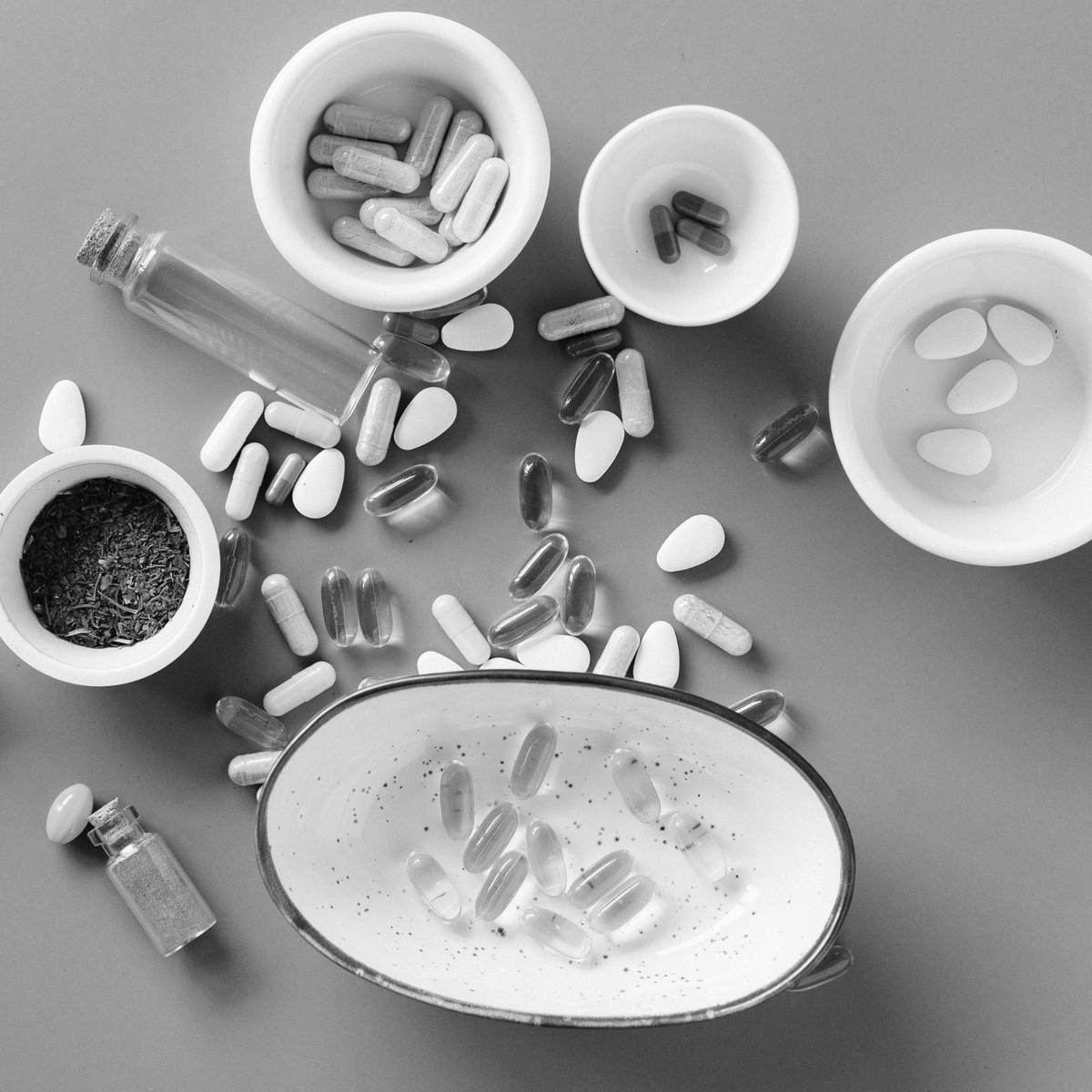 Assorted supplement pills and capsules arranged flat